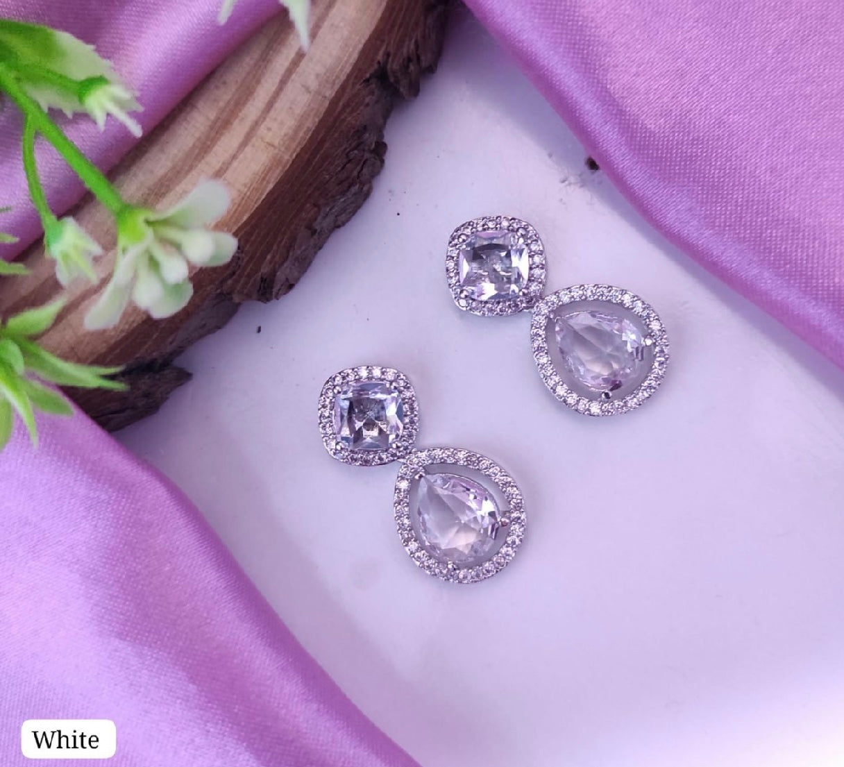 AD earrings: white