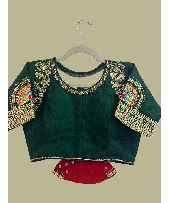 House Of Indian Wedding Attire deep green silk wedding blouse with gold embroidery, sequins, and colorful peacock motifs on sleeves.