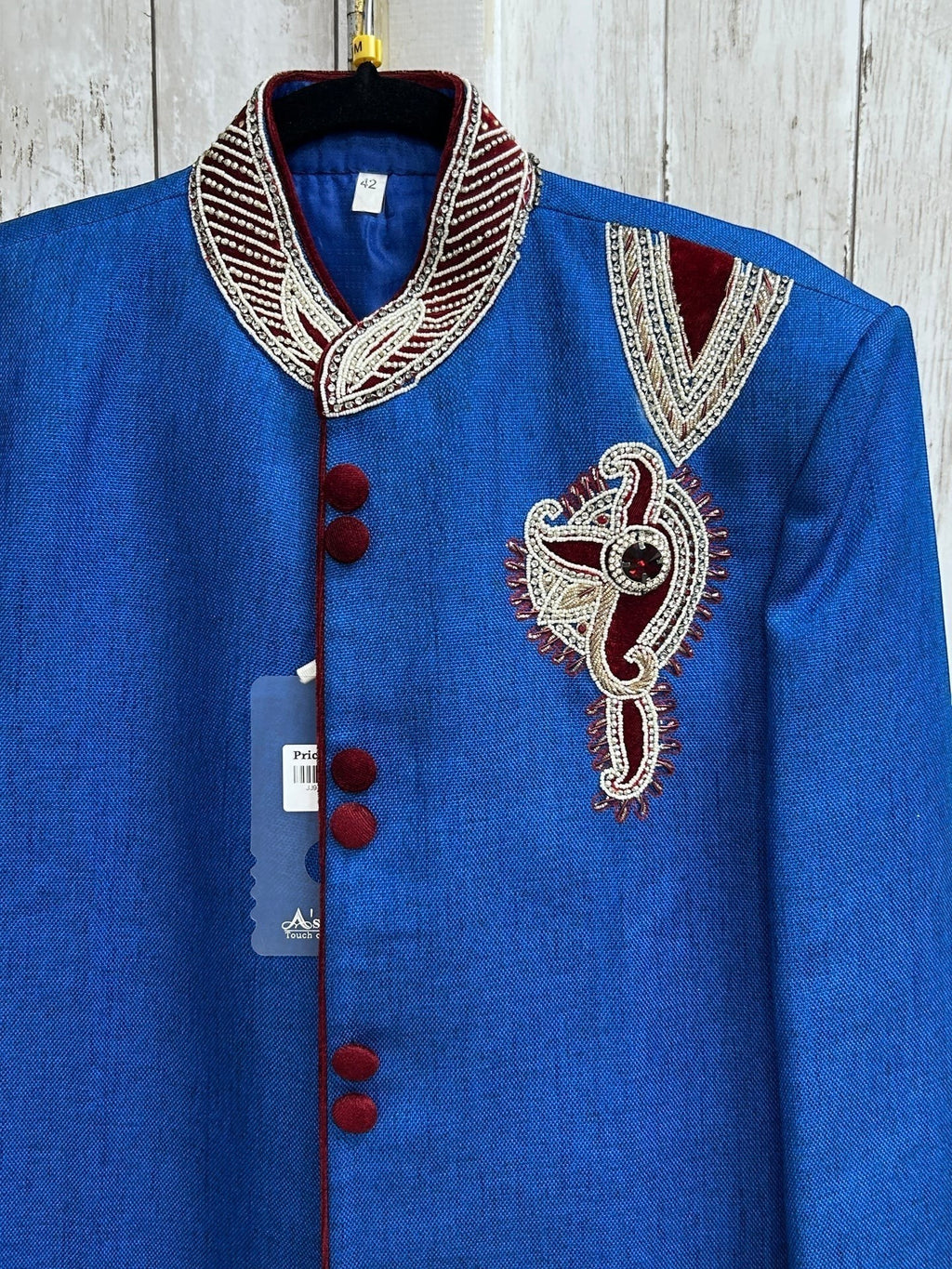 Kurti Connection USA blue sherwani jacket with intricate embroidery, mandarin collar, and red velvet button accents.