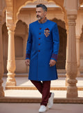 Kurti Connection USA blue sherwani jacket with red velvet accents, mandarin collar, and embroidery, worn by a man.