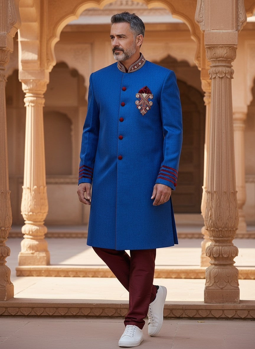 Kurti Connection USA blue sherwani jacket with red velvet accents, mandarin collar, and embroidery, worn by a man.