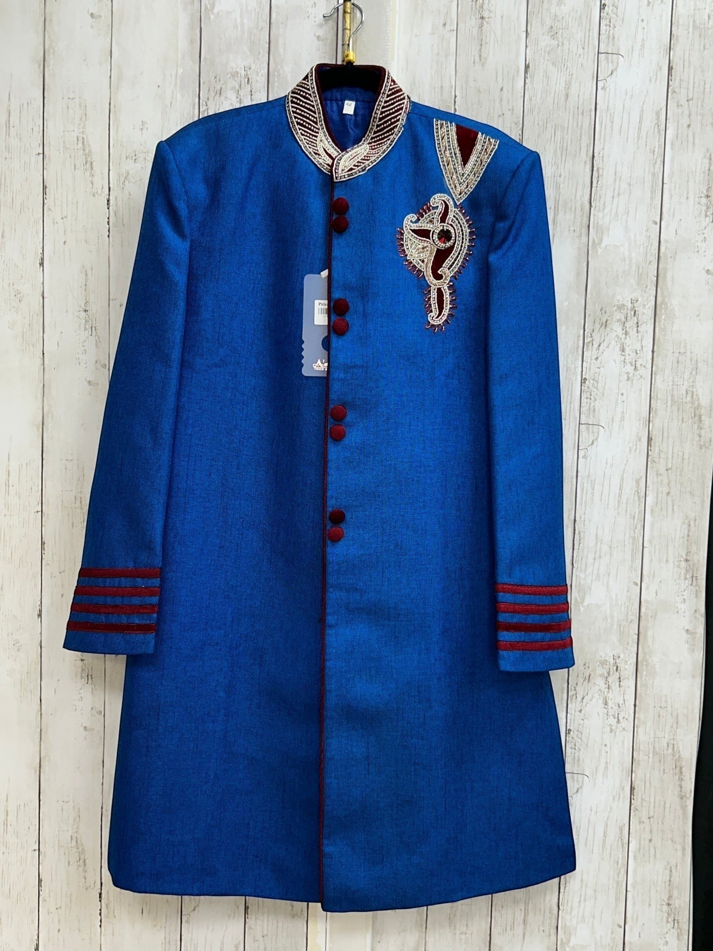 Kurti Connection USA blue sherwani jacket with red velvet accents, mandarin collar, and intricate chest embroidery.
