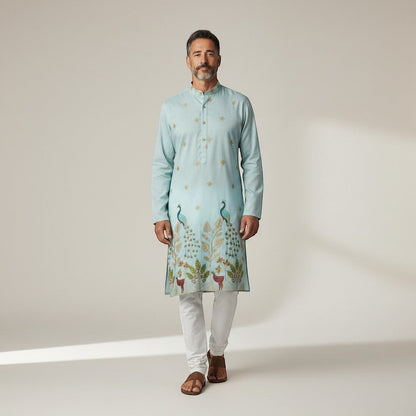 Kurti Connection USA light blue silk kurta set with intricate peacock embroidery and gold accents, paired with white pajama.
