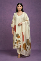 Kurti Connection USA cream botanical print kurta set with dupatta, featuring V-neck and lace trim. Earthy tones of rust, brown, ochre.