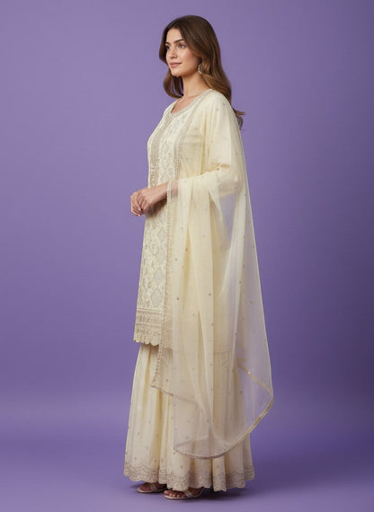 Kurti Connection USA cream silk blend kurti sharara set with silver embroidery and sequin dupatta.