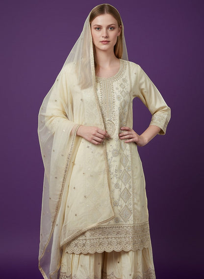 Kurti Connection USA cream silk blend kurti sharara set with silver embroidery and sequin dupatta.