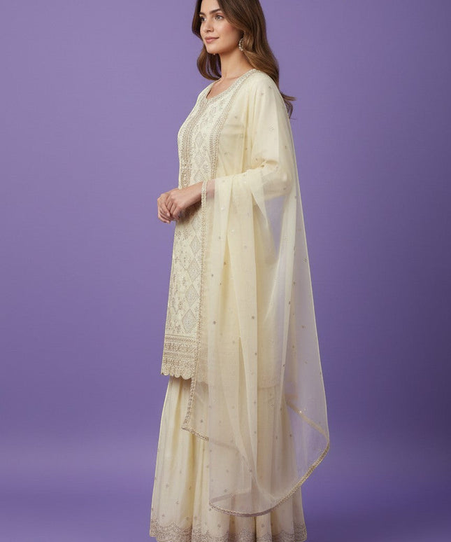 Kurti Connection USA cream silk blend kurti sharara set with silver embroidery and sequin dupatta.