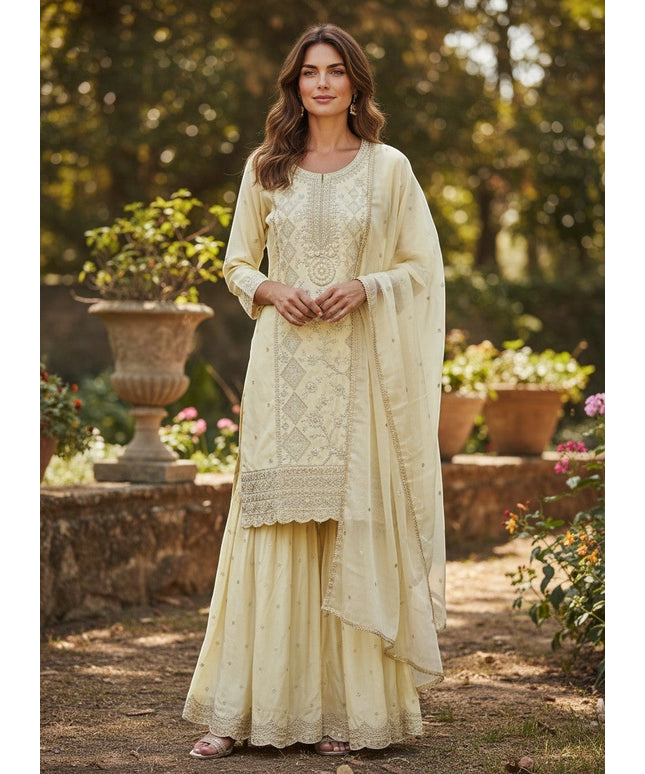 Kurti Connection USA cream silk blend kurti sharara set with silver embroidery and sequin dupatta.