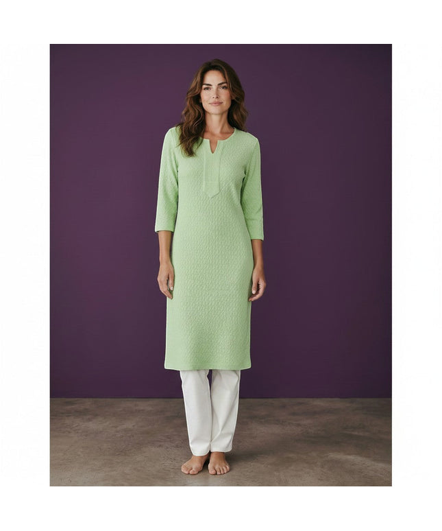 Kurti Connection USA light green textured cotton kurti with 3/4 sleeves and V-neck. Model is barefoot against a purple backdrop.