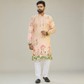 Kurti Connection USA men's peach floral print kurta with mandarin collar and white pants. Lightweight fabric with lotus motif.