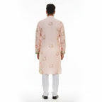 Kurti Connection USA men's light peach floral print kurta with mandarin collar and white pants.