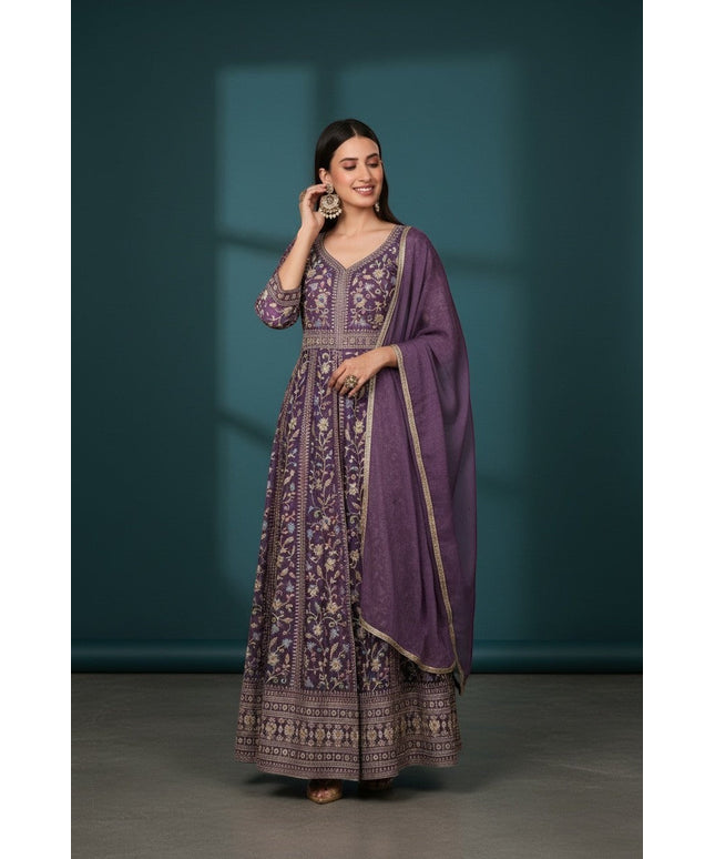 Kurti Connection USA purple embroidered Anarkali suit with all-over print and matching dupatta. Model wears statement earrings.