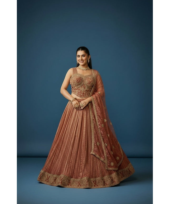Kurti Connection USA woman in embroidered rose gold lehenga set with intricate gold detailing and matching dupatta.