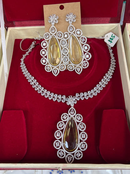 Kurti Connection USA statement necklace set with teardrop yellow stones and clear crystals, matching dangle earrings.