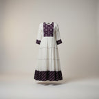 Kurti Connection USA white tiered maxi dress with embroidered purple yoke and cuffs, long sleeves, and a flowing silhouette.
