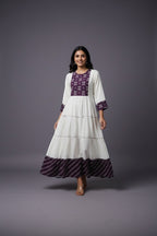 Kurti Connection USA white tiered maxi dress with purple embroidered yoke and cuffs, flowing silhouette.